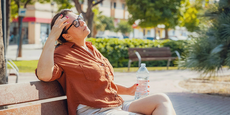sick woman on park bench